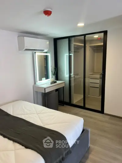Modern bedroom with mirrored closet and sleek design