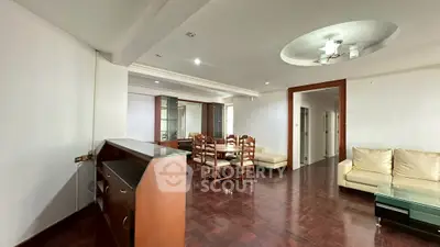 Spacious living room with elegant wooden flooring and modern ceiling design