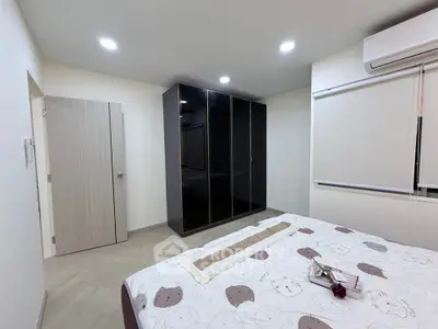 Modern bedroom with sleek wardrobe and cozy bed in minimalist design.