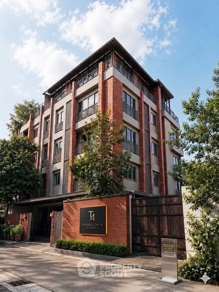 Modern apartment building with brick facade and lush greenery in Thonglor area.