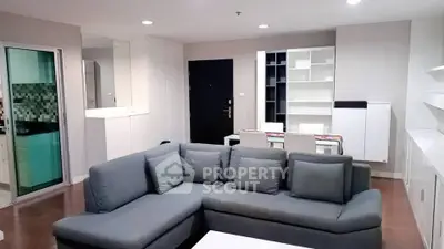 Spacious modern living room with sleek gray sofa and open layout design