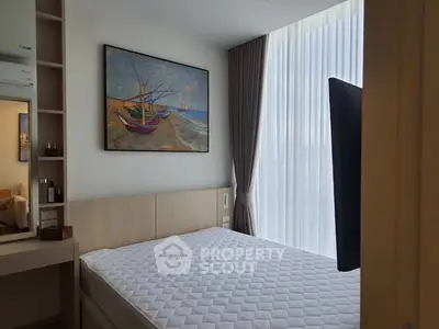 Modern bedroom with large window and elegant decor