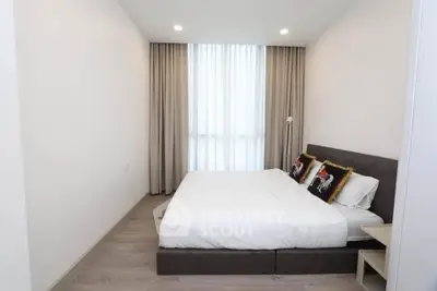 Modern minimalist bedroom with cozy bed and elegant decor