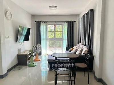 Modern living room with sleek furniture and natural light, perfect for relaxation and entertainment.