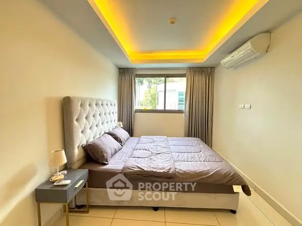 Modern bedroom with elegant lighting and plush bed in a stylish apartment.