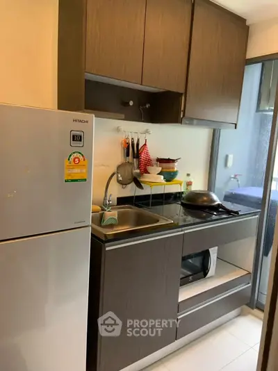 Compact modern kitchen with sleek cabinets and stainless steel appliances