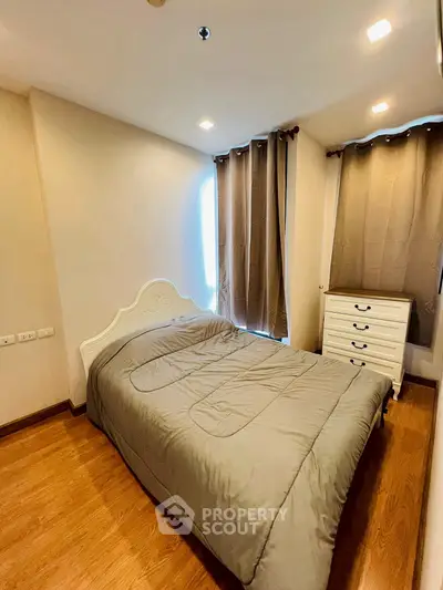 Cozy bedroom with elegant bed and natural light, perfect for relaxation.