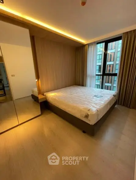 Modern bedroom with large window and wooden accents in a stylish apartment