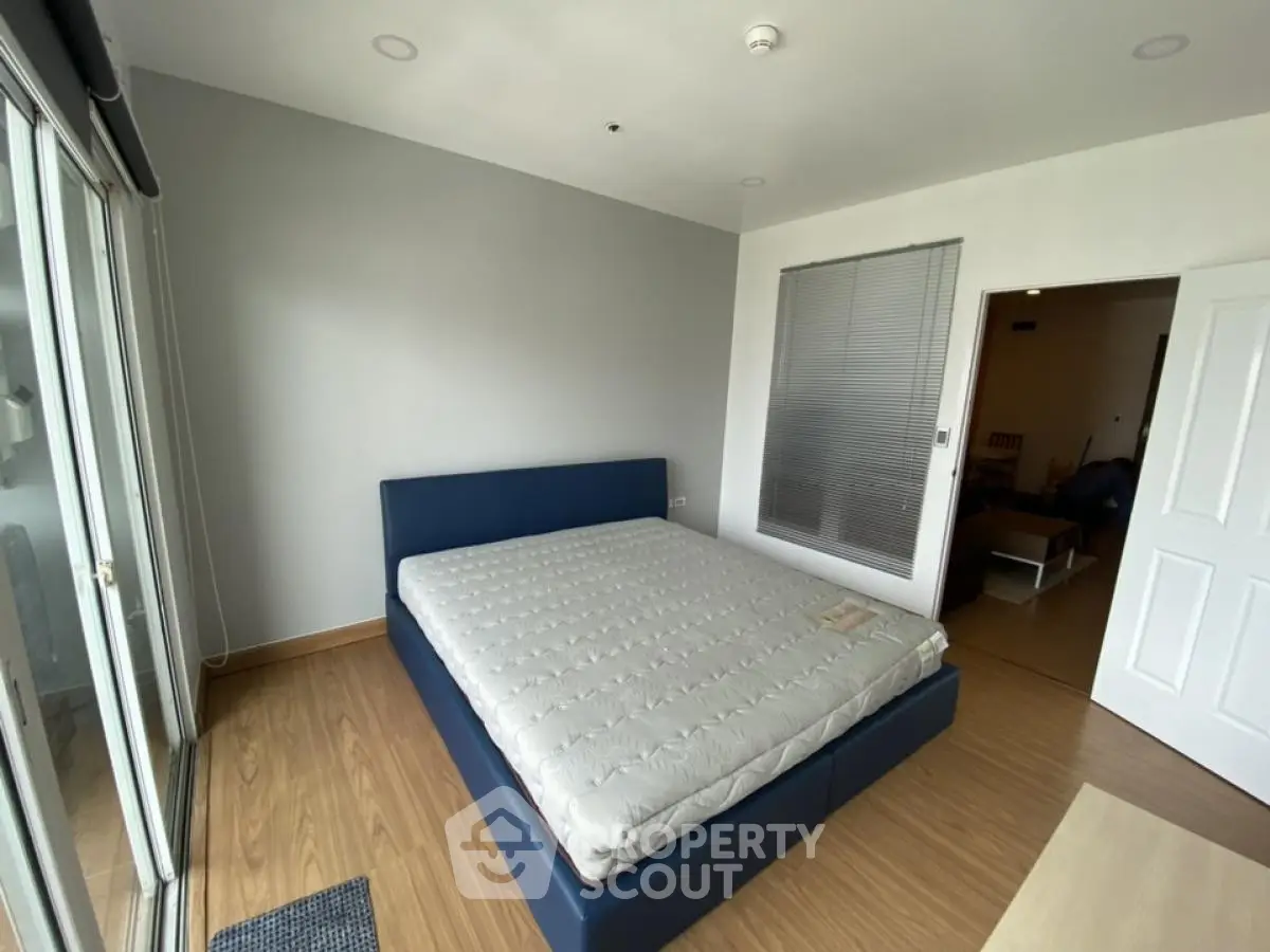 Spacious bedroom with modern design and large windows for natural light