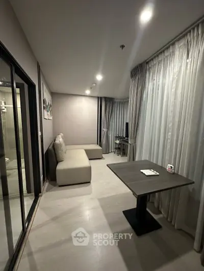 Modern living room with sleek design and large windows, perfect for urban living.