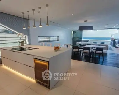 Luxurious open-plan kitchen and dining area with ocean view