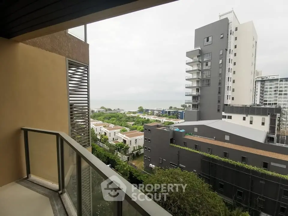 Stunning balcony view of modern urban landscape with lush greenery and contemporary architecture.