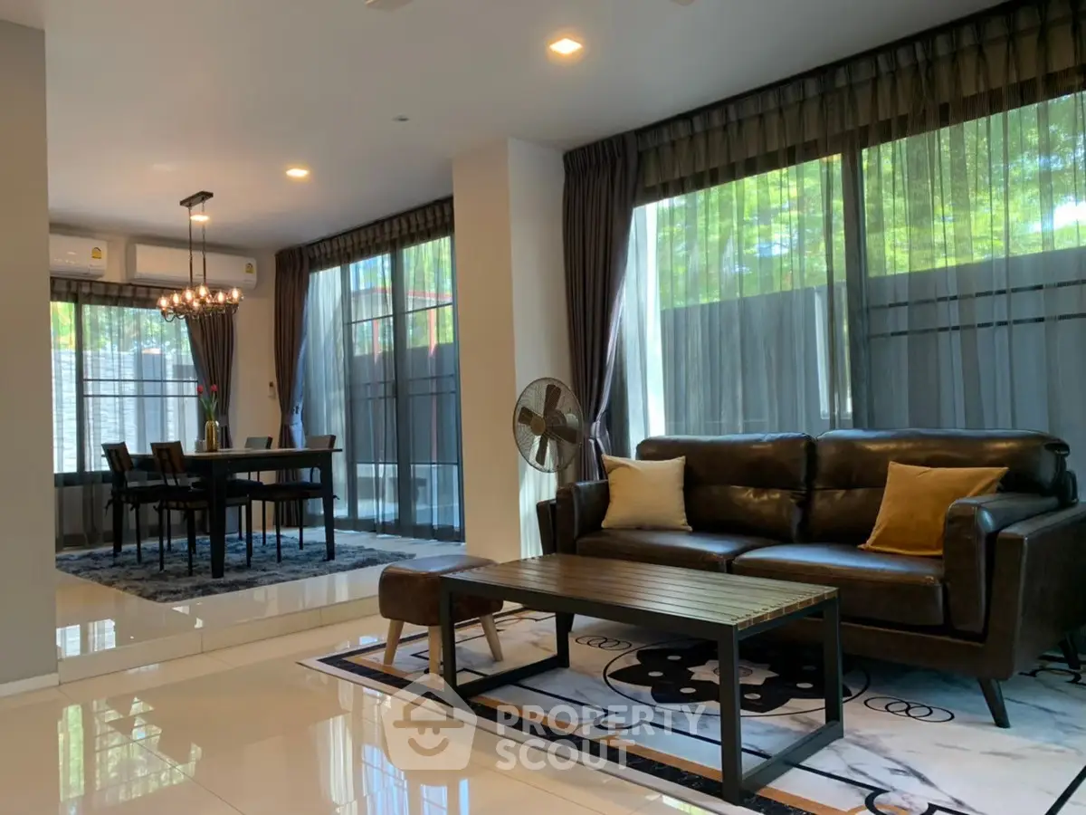 Spacious modern living room with elegant dining area and large windows.