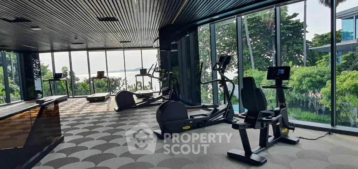 Modern gym with panoramic sea view and state-of-the-art equipment.