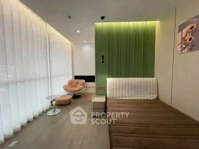 Modern living room with stylish furniture and elegant decor, featuring a cozy seating area and soft lighting.