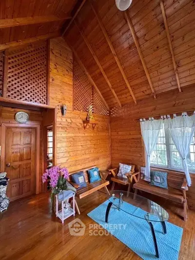 Charming wooden living room with high ceilings and cozy decor