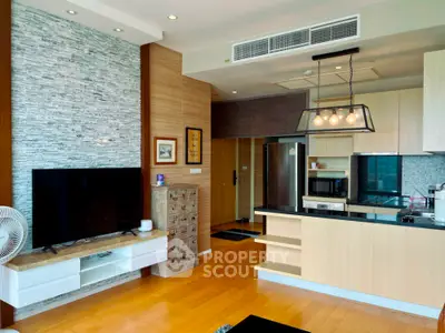 Modern open-layout living room with stylish kitchen and wooden flooring