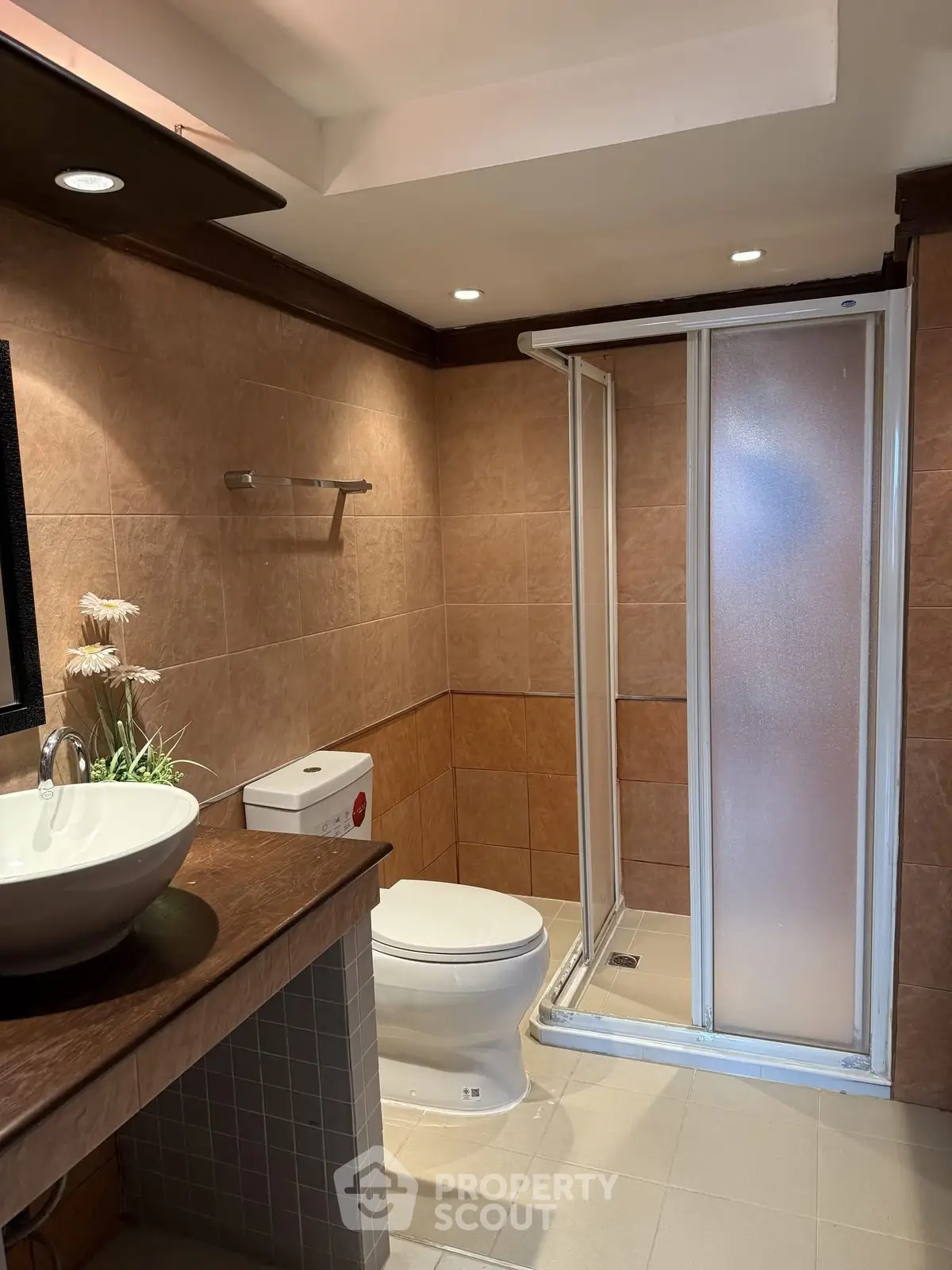 Modern bathroom with shower and stylish sink in a cozy real estate property.
