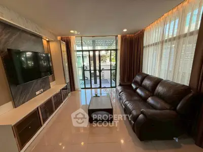 Spacious living room with modern decor and large windows offering natural light.