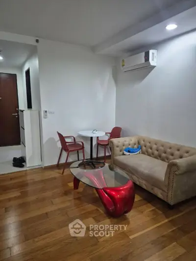 Modern living room with stylish furniture and wooden flooring in a cozy apartment.