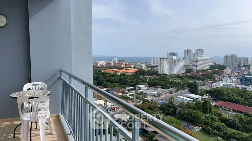 Stunning balcony view of cityscape and ocean, perfect for relaxation and enjoying the scenery.