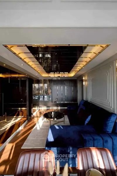 Luxurious modern living room with plush blue sofa and elegant lighting