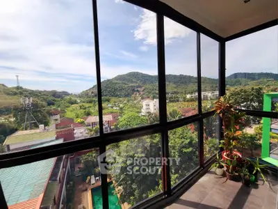 Stunning balcony view with lush greenery and mountains, perfect for nature lovers seeking tranquility.