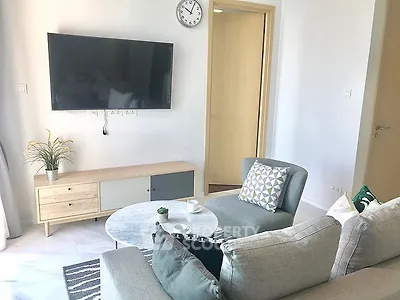 Modern living room with wall-mounted TV and stylish furniture