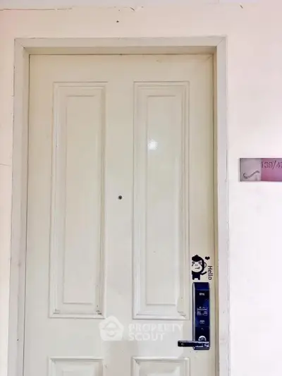 Modern apartment entrance with digital lock and stylish door design.