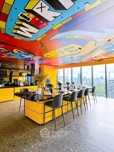 Vibrant modern kitchen with colorful ceiling art and stunning city skyline view