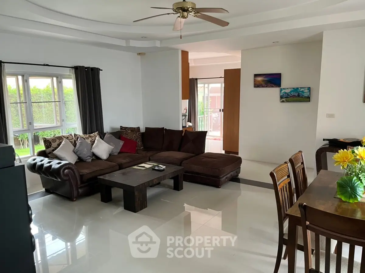 Spacious living room with modern decor and natural light, perfect for family gatherings.