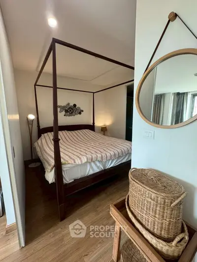 Charming bedroom with canopy bed and wicker accents, perfect for cozy living.