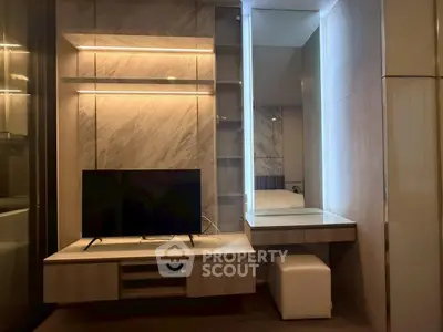 Modern living room with sleek TV unit and elegant lighting