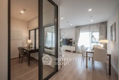 Modern open-plan living and dining area with elegant decor and natural light.