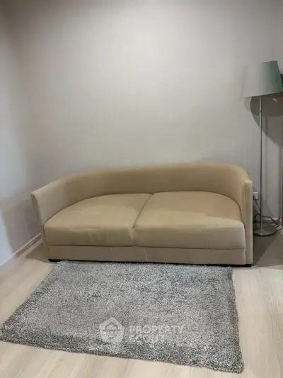 Cozy living room with modern beige sofa and stylish floor lamp