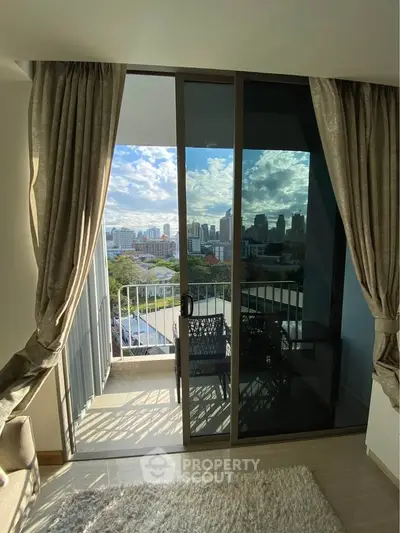 Chic apartment balcony with stunning city view and elegant curtains