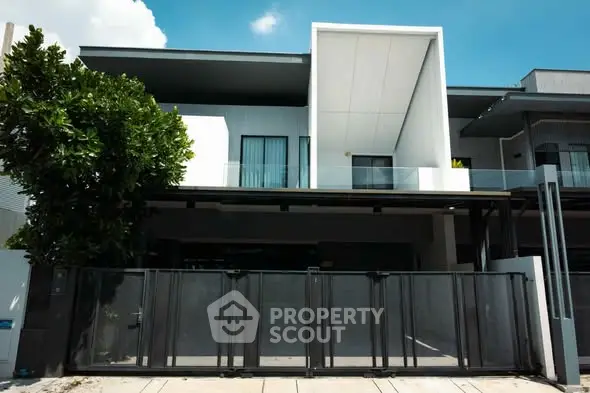 Modern two-story house with sleek design and gated entrance