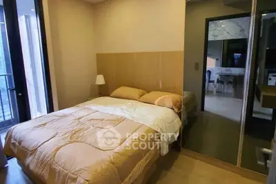 Cozy bedroom with modern decor and mirrored wardrobe in a stylish apartment.