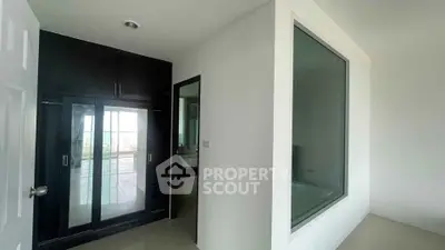 Modern bathroom with sleek glass shower and large window for natural light
