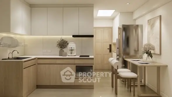 Modern kitchen with sleek cabinetry and stainless steel appliances in a cozy apartment.
