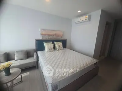 Spacious modern bedroom with air conditioning and elegant decor