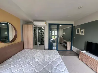 Modern bedroom with ensuite bathroom and stylish decor in a contemporary apartment.