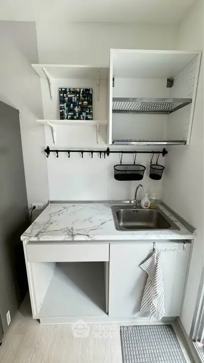Compact modern kitchen with marble countertop and open shelving