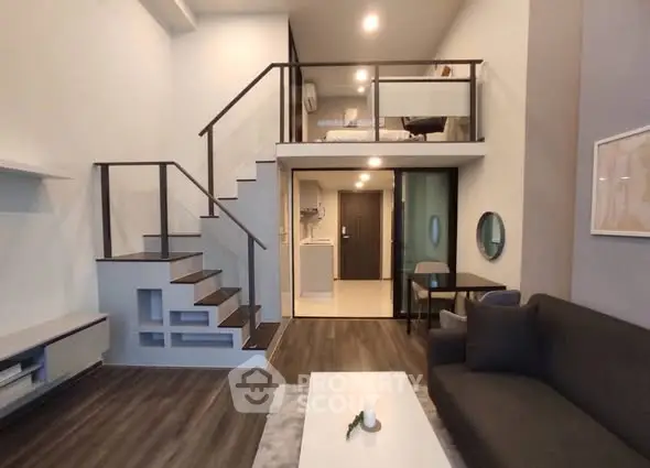 Modern loft apartment with mezzanine bedroom and stylish living area.