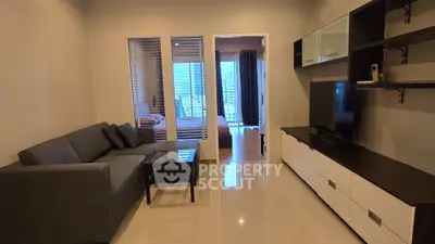 Modern living room with sleek furniture and large TV unit, perfect for relaxation.