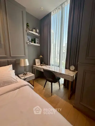 Modern bedroom with elegant decor and city view, featuring a sleek desk and comfortable bed.