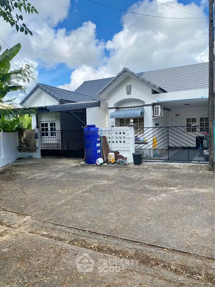 Charming single-story home with spacious driveway and modern exterior design.