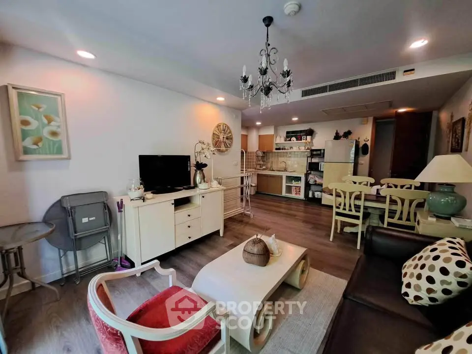 Charming living room with elegant decor and open kitchen layout in modern apartment.