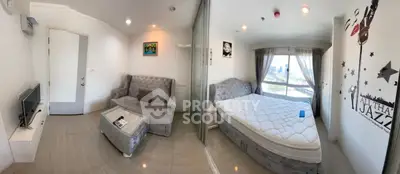 Modern studio apartment with stylish decor and city view, featuring a cozy living area and comfortable bed.