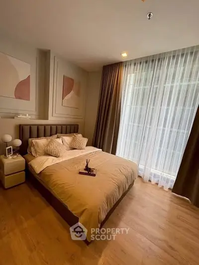 Elegant bedroom with modern decor and large window for natural light